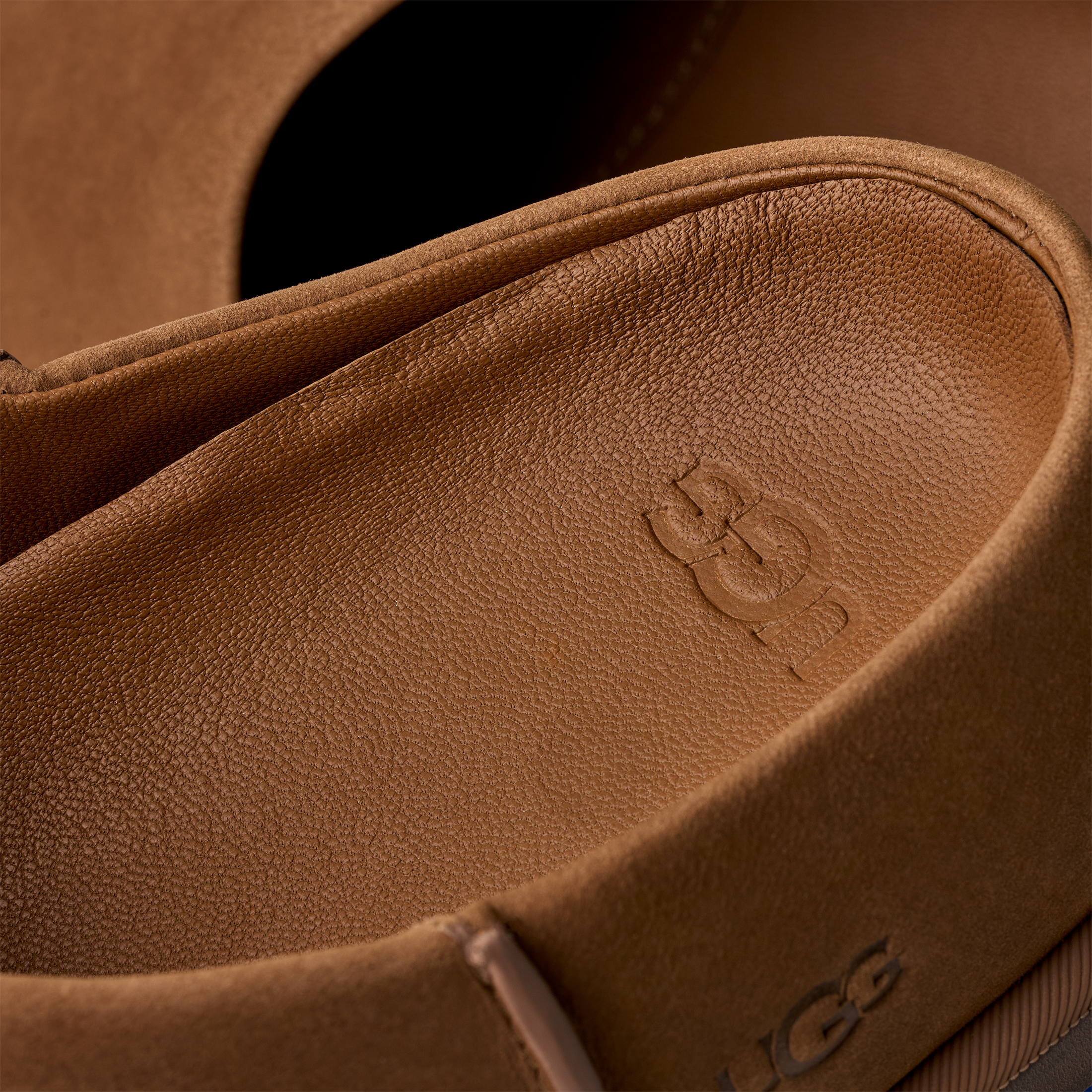Close-up of a brown leather shoes with UGG logo