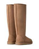 A pair of tall, knee-high UGG boots in a warm tan suede finish, shown from the back on a clean white background.