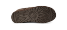 The textured brown rubber outsole of a shoe, showing a detailed tread pattern and a circular UGG logo embossed in the center, on a white background.