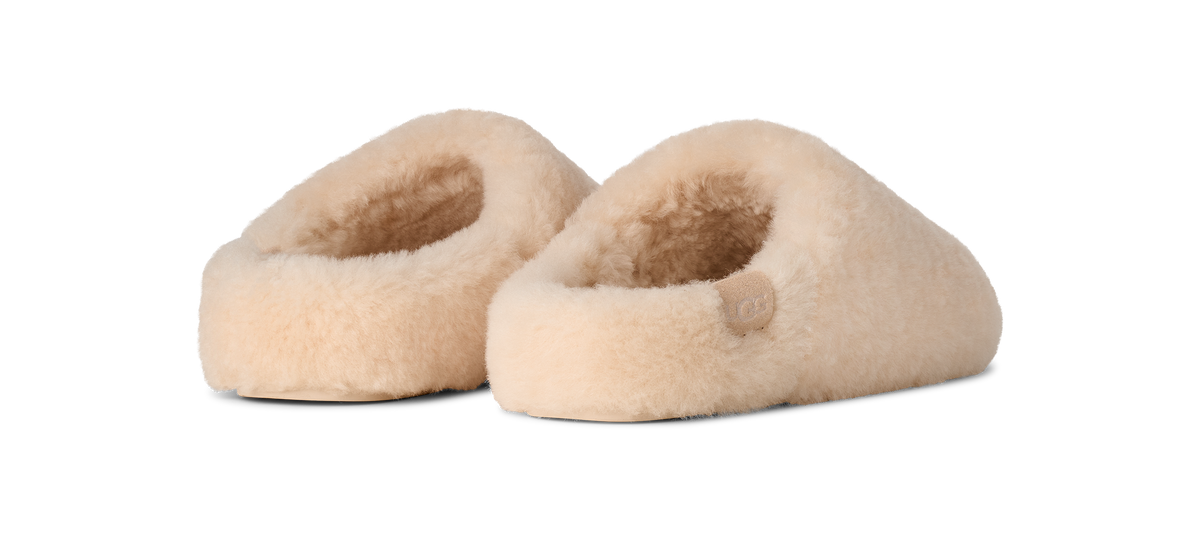 Pair of beige slippers on a white background