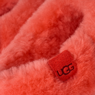 Close-up of red UGG logo on fluffy fabric