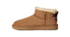 Brown suede boot with white fur lining on a white background