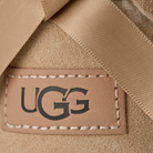 Close-up of a UGG label on beige fabric
