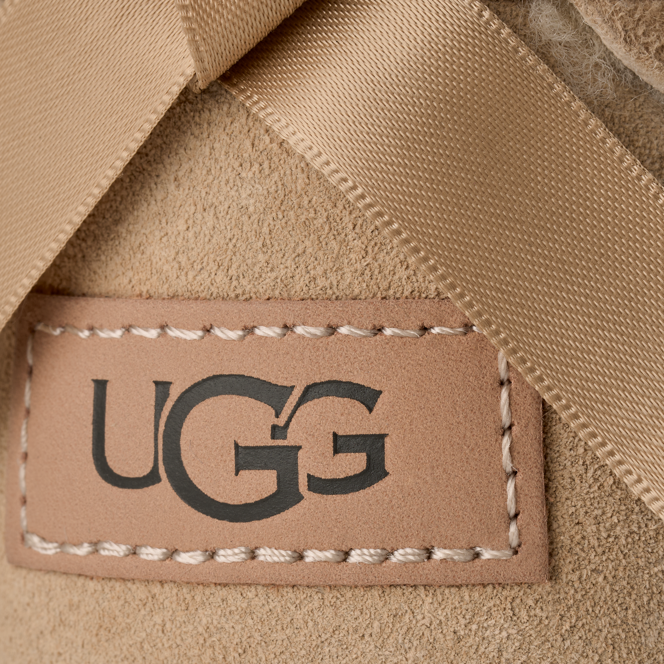 Close-up of a UGG label on beige fabric