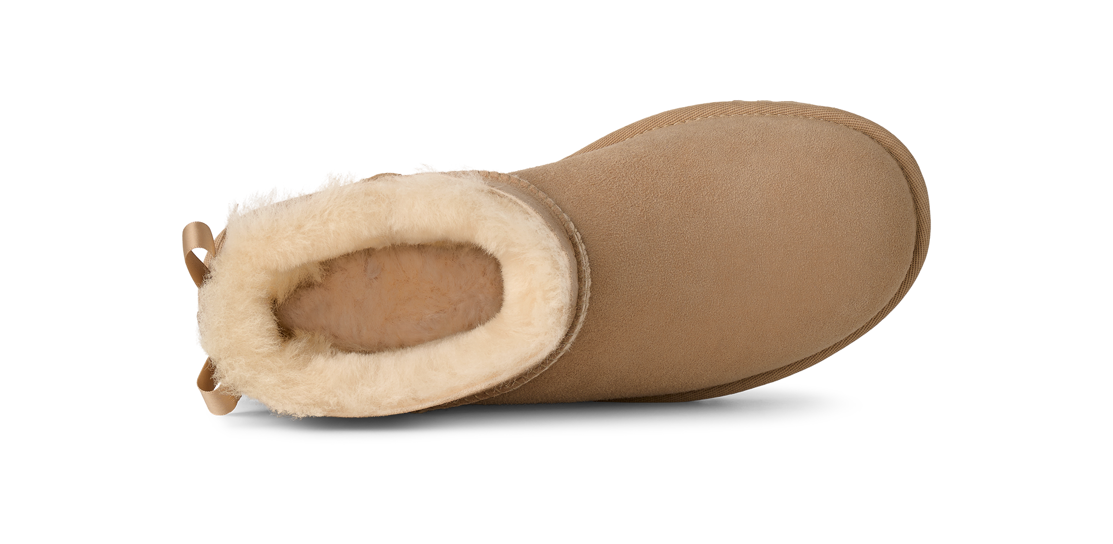 A single tan suede ankle boot with a thick cream shearling lining, shown from a side profile view against a white background.