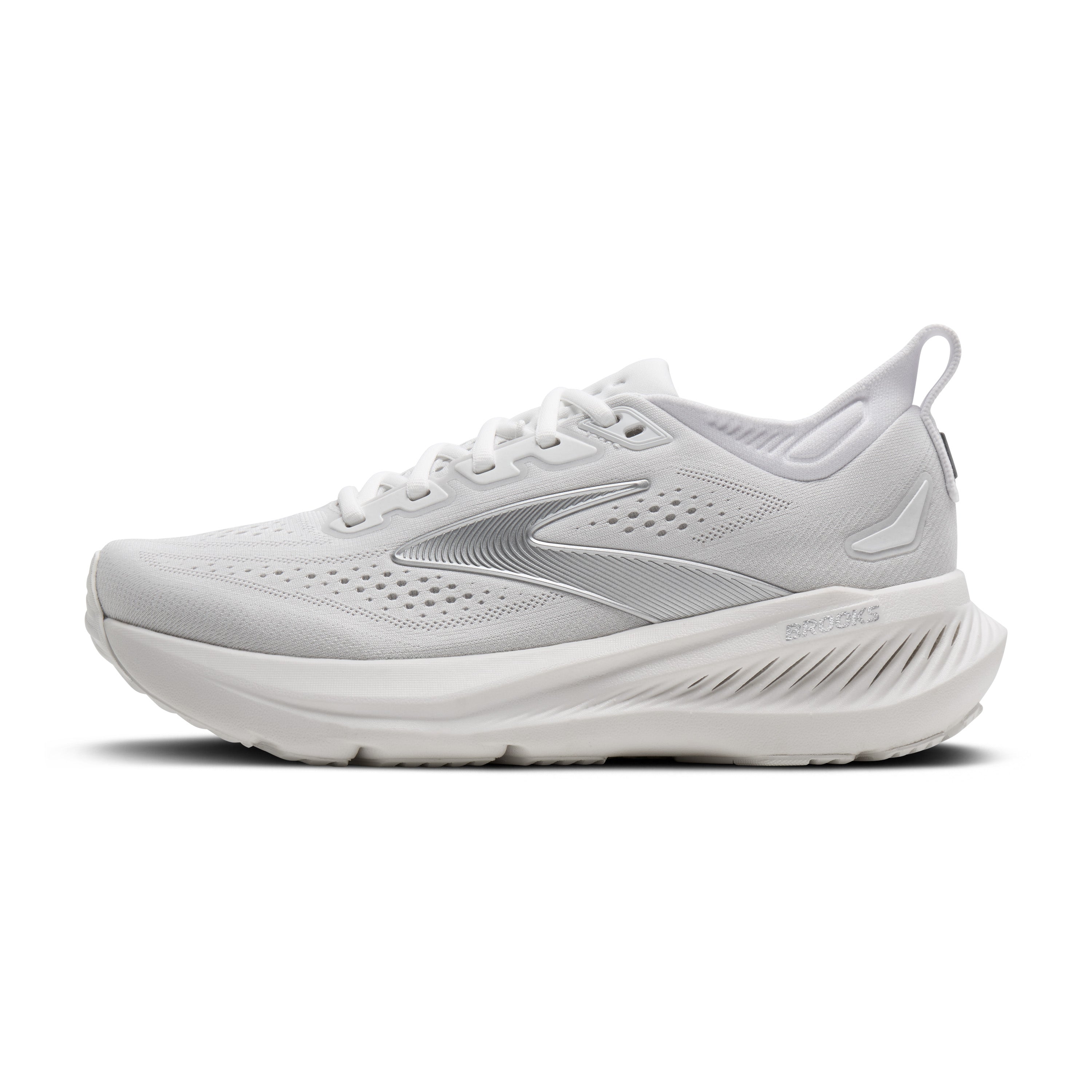 White running shoe with green accents on a white background