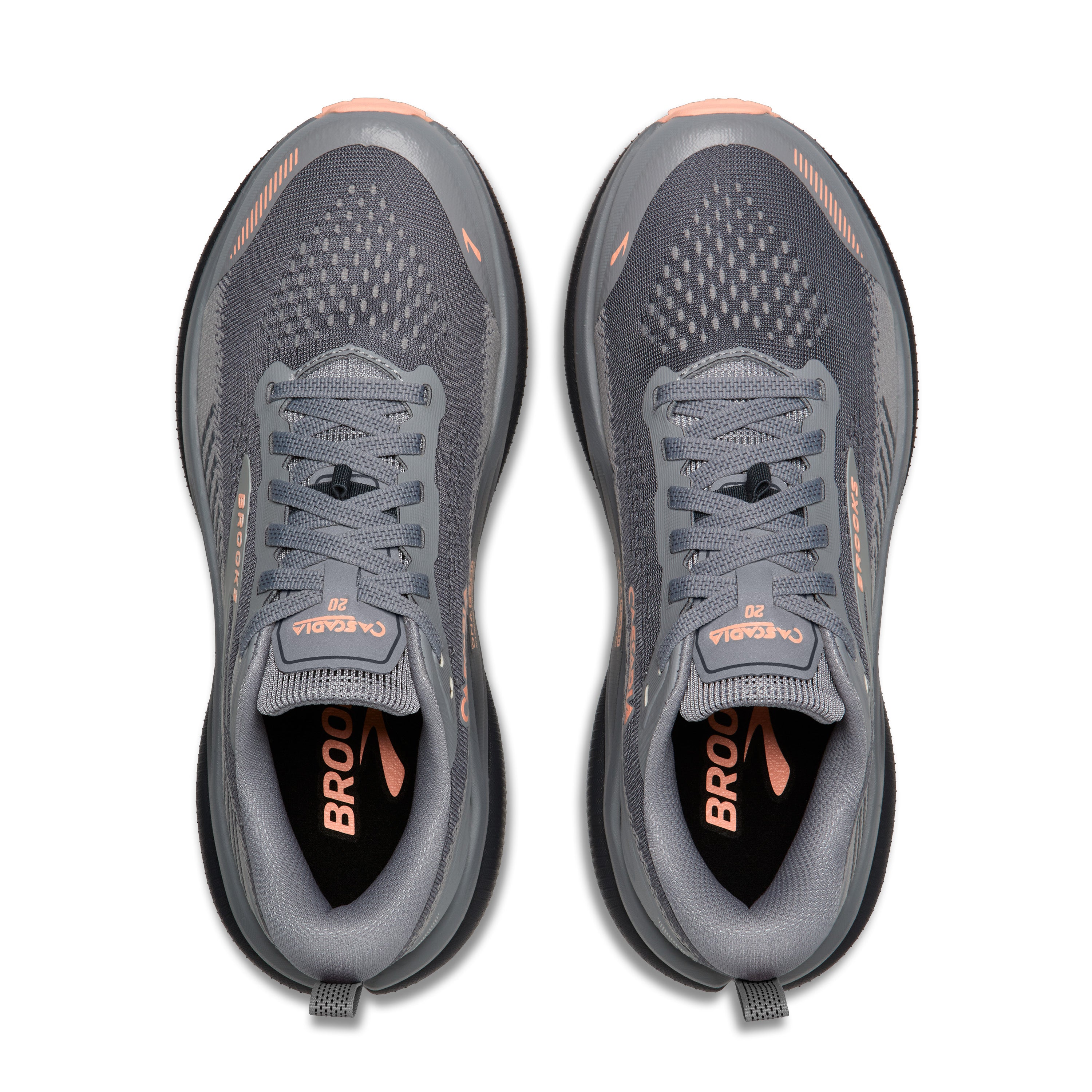 Pair of gray running shoes with orange accents on a white background