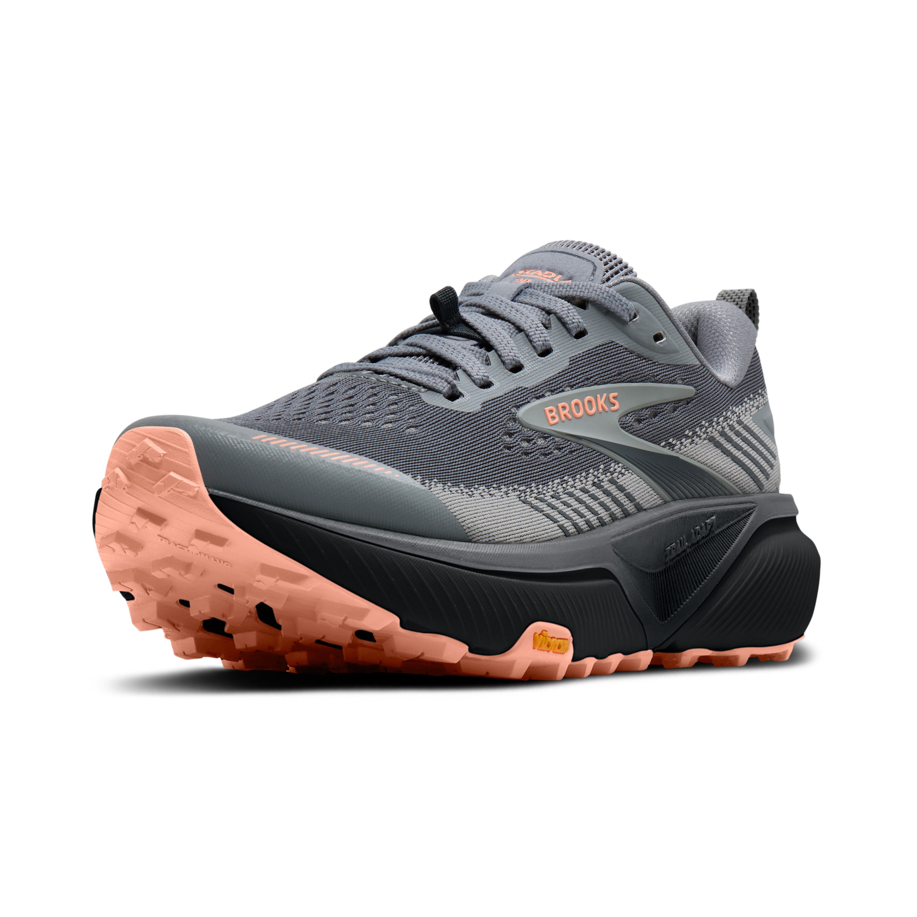Gray and black running shoe with orange sole on a white background