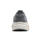 Gray running shoe with a white sole on a white background