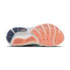 Close-up of a running shoe sole with white, orange, and blue colors on a white background