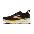 Black running shoe with pink and yellow accents on a white background