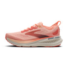 Pink running shoe with white sole on a white background