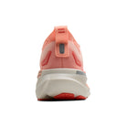 Coral running shoe with white sole on a white background