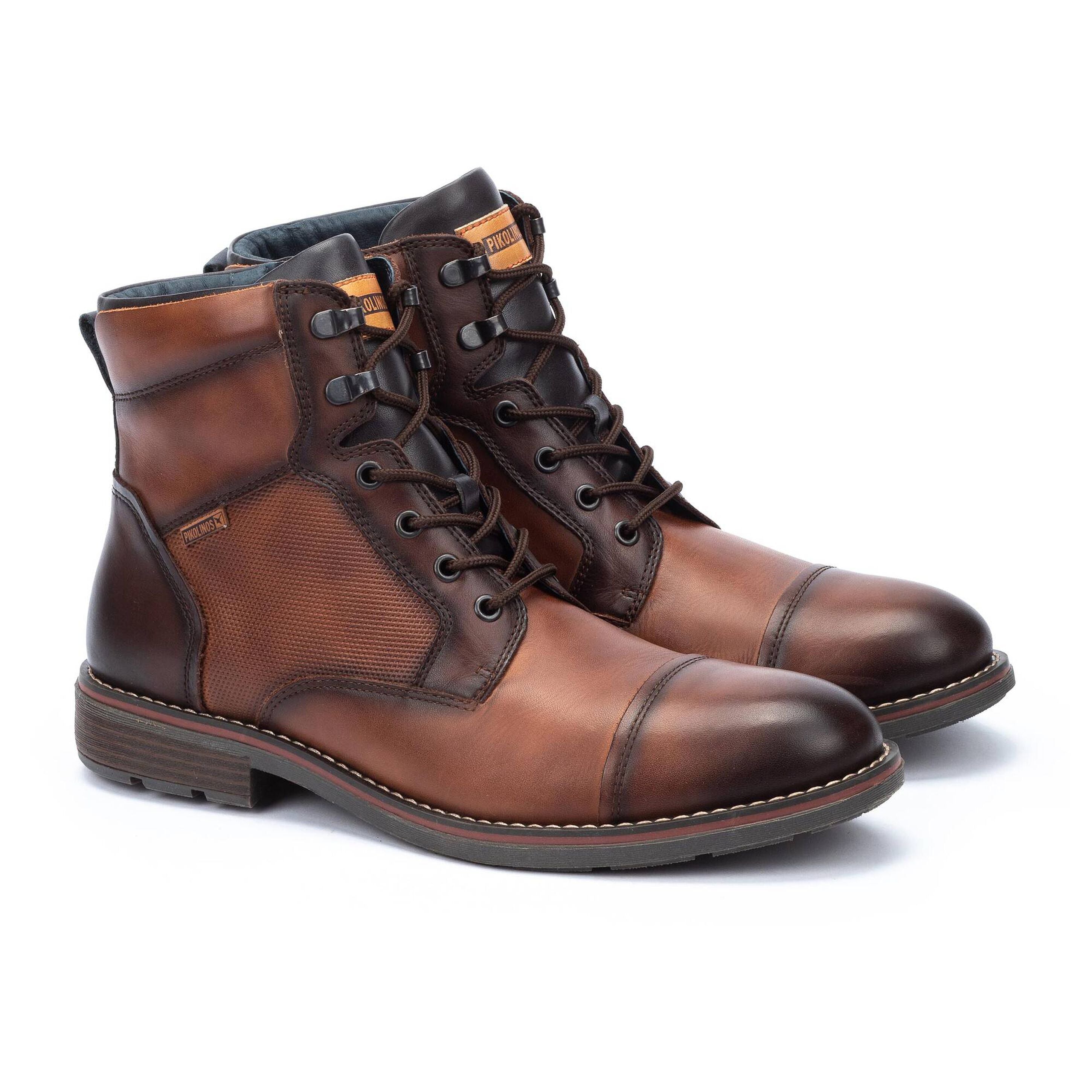 Pair of brown leather boots on a white background