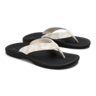 Pair of black and white floral flip-flops on a white background