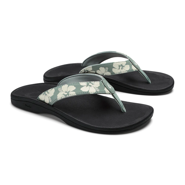 Pair of black sandals with floral straps on a white background