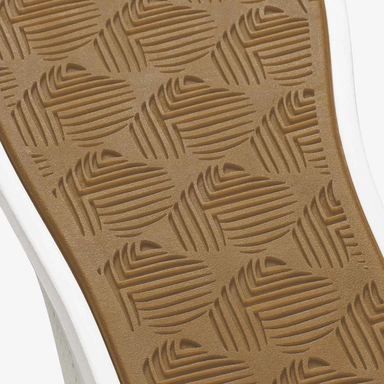Close-up of a textured brown mat with geometric pattern on a white background
