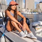 Woman sitting on a boat with city skyline in the background