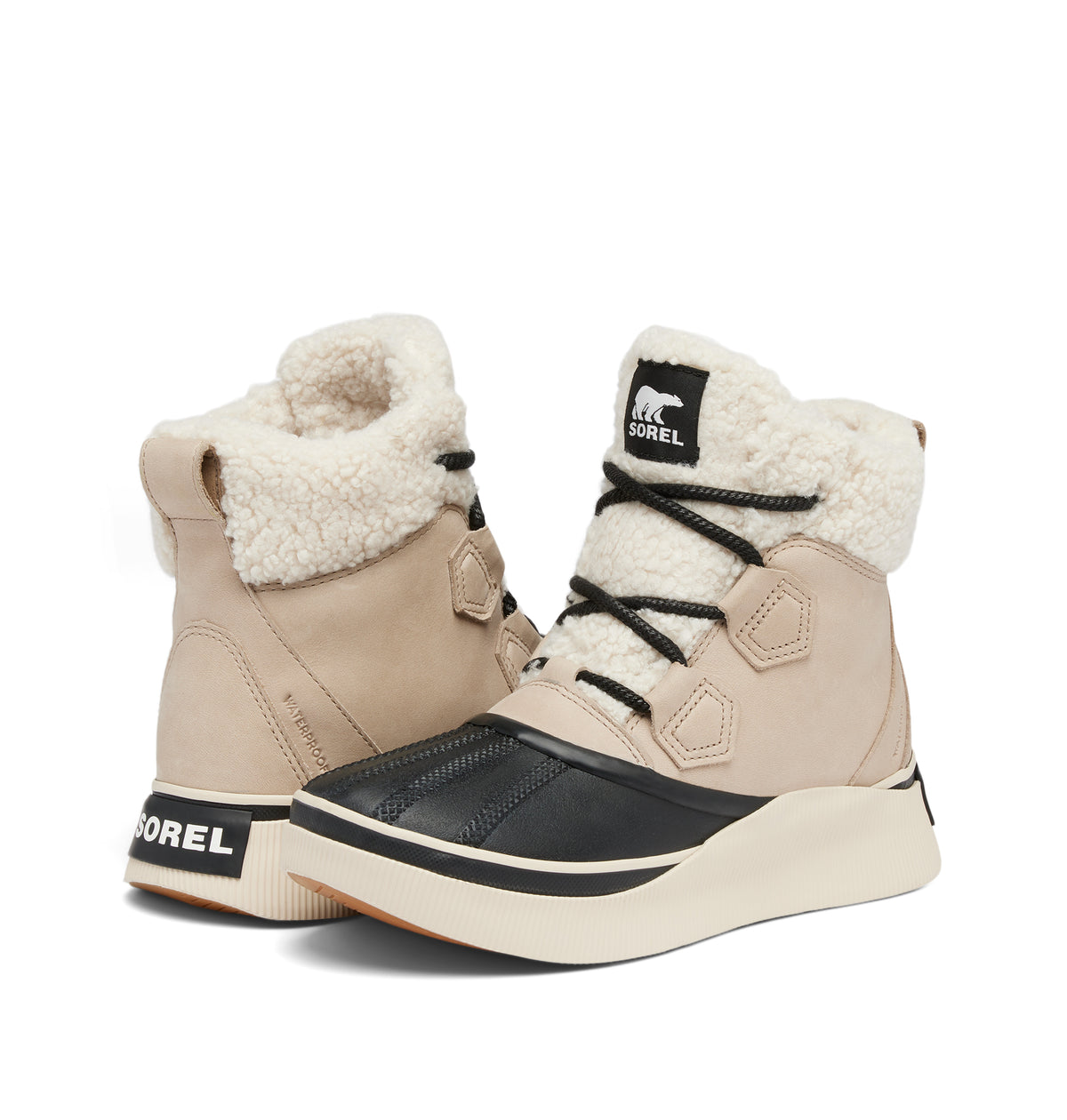 A pair of Sorel mid-height winter boots in beige and black, featuring a thick cream-colored faux-fur collar and a chunky cream sole, shown against a plain white background.