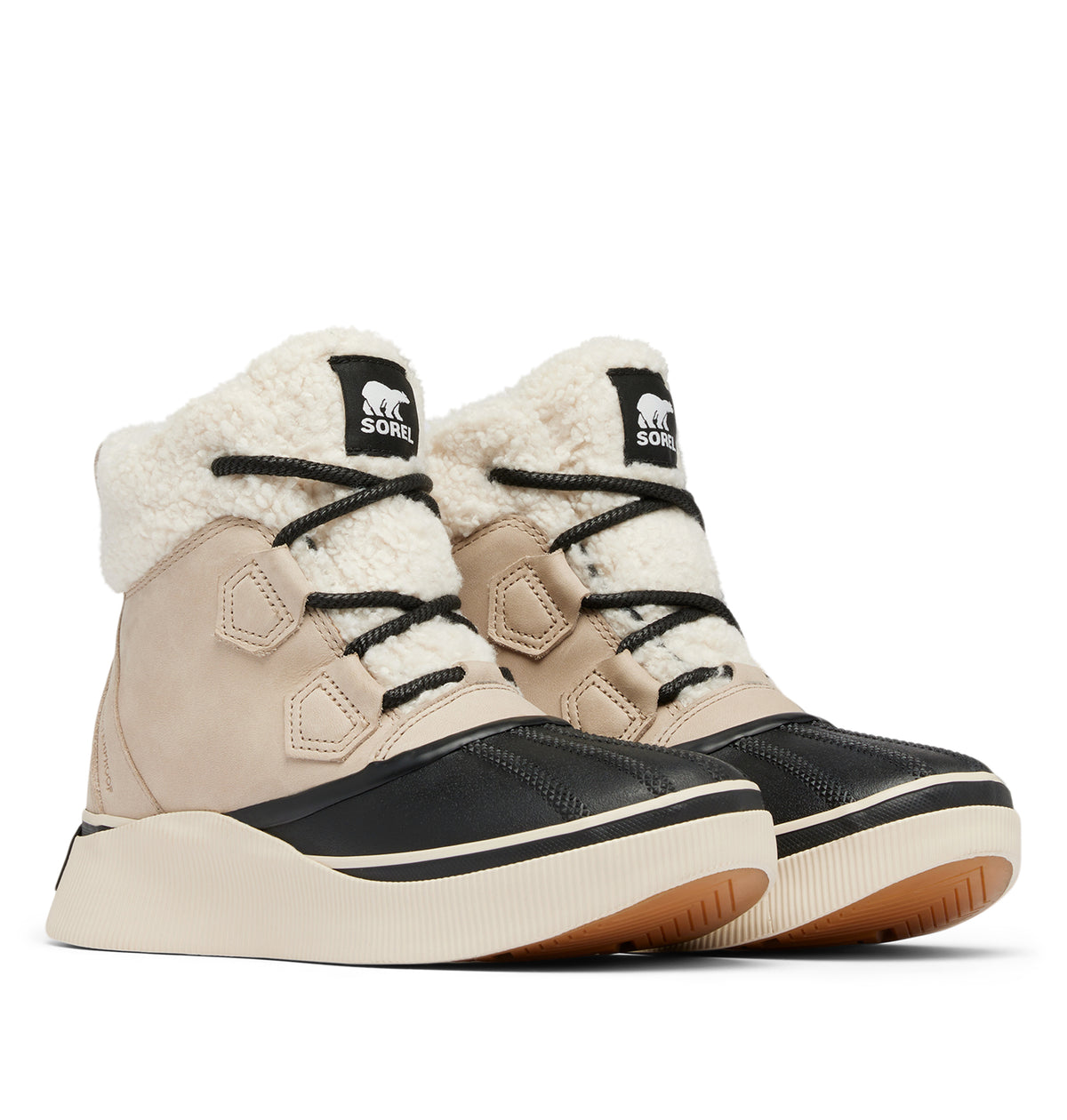 A pair of Sorel snowboarder boots in beige and black with a cream sherpa lining, shown against a plain white background.