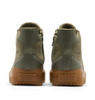 A pair of Sore boots shown from the back, featuring olive green leather and suede uppers with white contrast stitching and thick brown lug soles.
