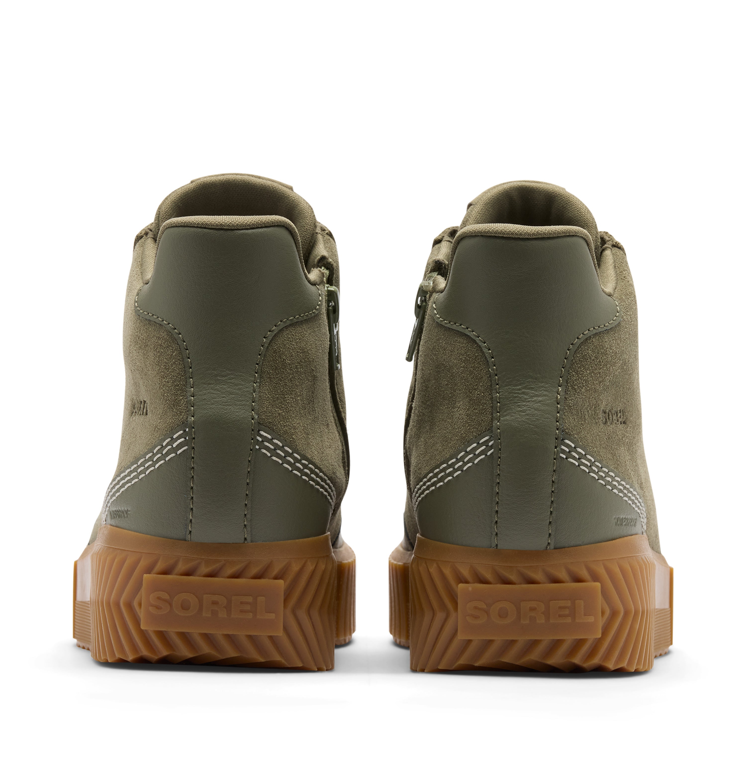 A pair of Sore boots shown from the back, featuring olive green leather and suede uppers with white contrast stitching and thick brown lug soles.