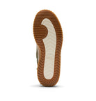 The outsole of a shoe shown from a top-down view, featuring a brown gum rubber tread with a cream-colored center section.