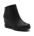 A black leather wedge ankle boot with a side zipper and a chunky lug sole, shown from a three-quarters angle on a white background.