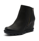 A black leather ankle boot with a wedge heel and a side zipper, shown from a three-quarters angle on a white background.