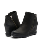 A pair of black wedge ankle boots with side zippers, shown on a light gray background.