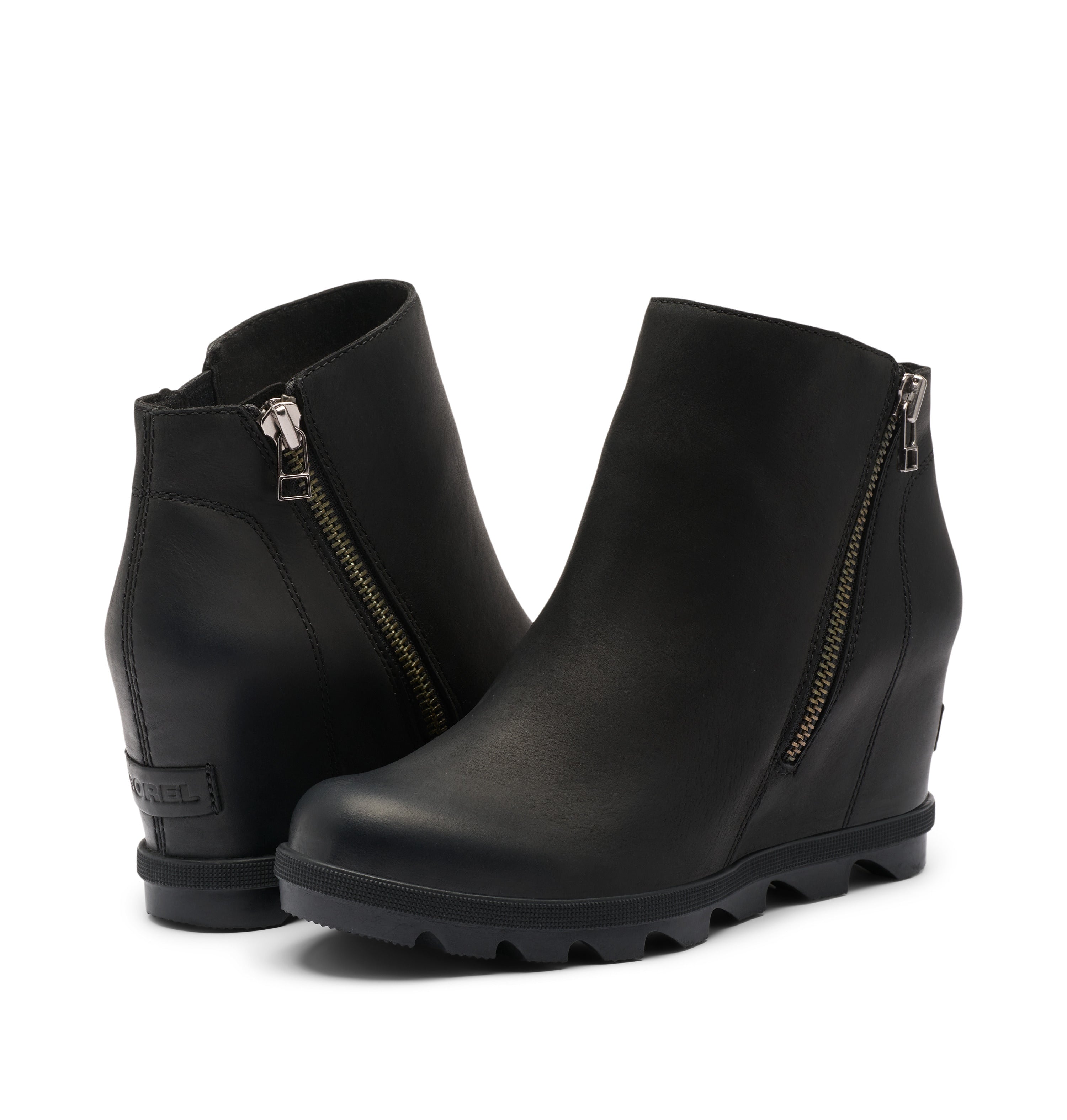 A pair of black wedge ankle boots with side zippers, shown on a light gray background.