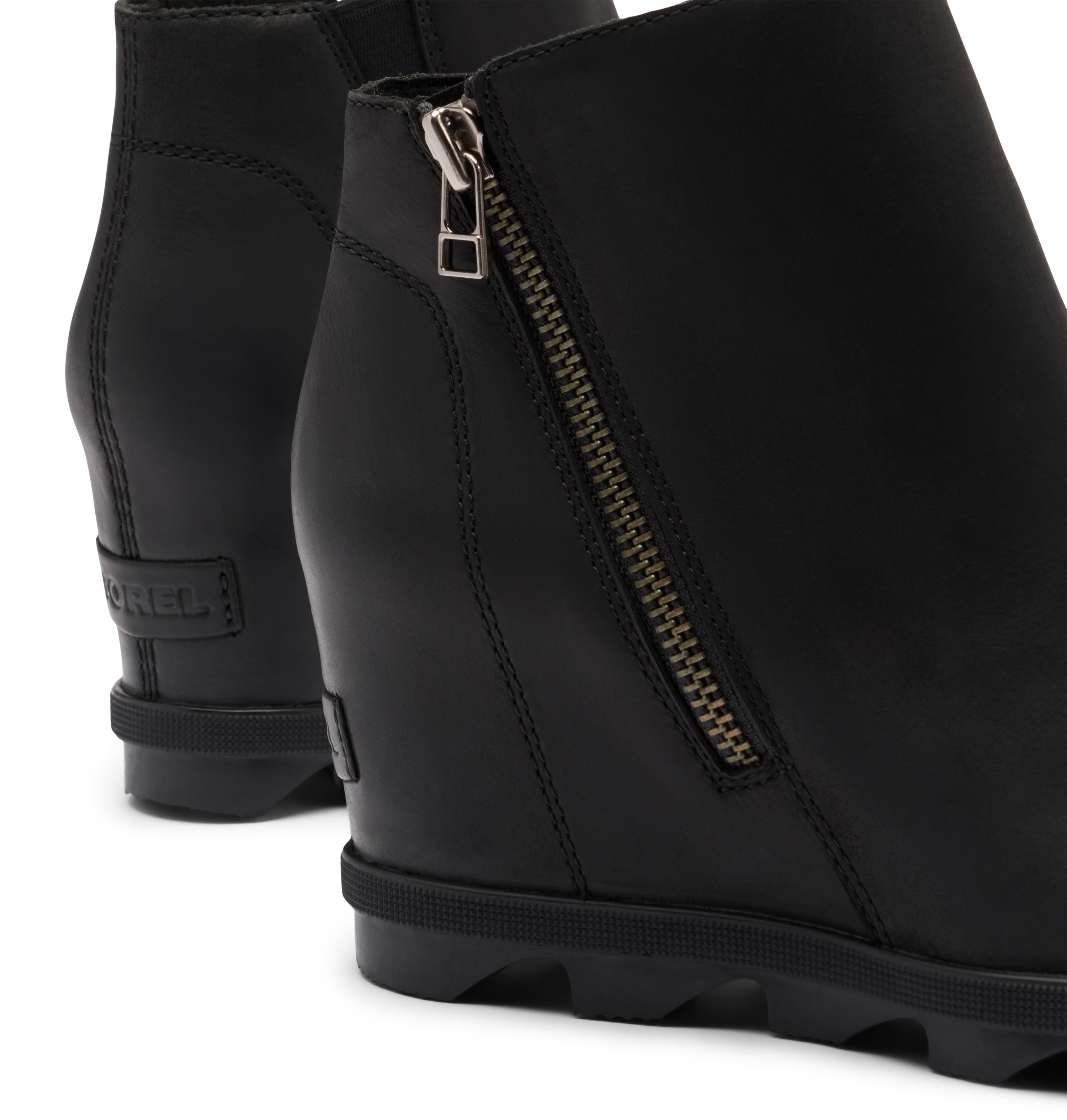 Black wedge ankle boots with a side zipper and a visible Sorel brand tab on the heel, shown on a white background.