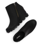 A pair of black waterproof ankle rain boots with side zippers, shown from top and side angles on a white background. The brand name 'SOREL' is visible on the inner sole of the bottom boot.