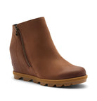 A brown leather wedge ankle boot with a side zipper and a chunky lug sole, shown from a three-quarters angle on a light beige background.