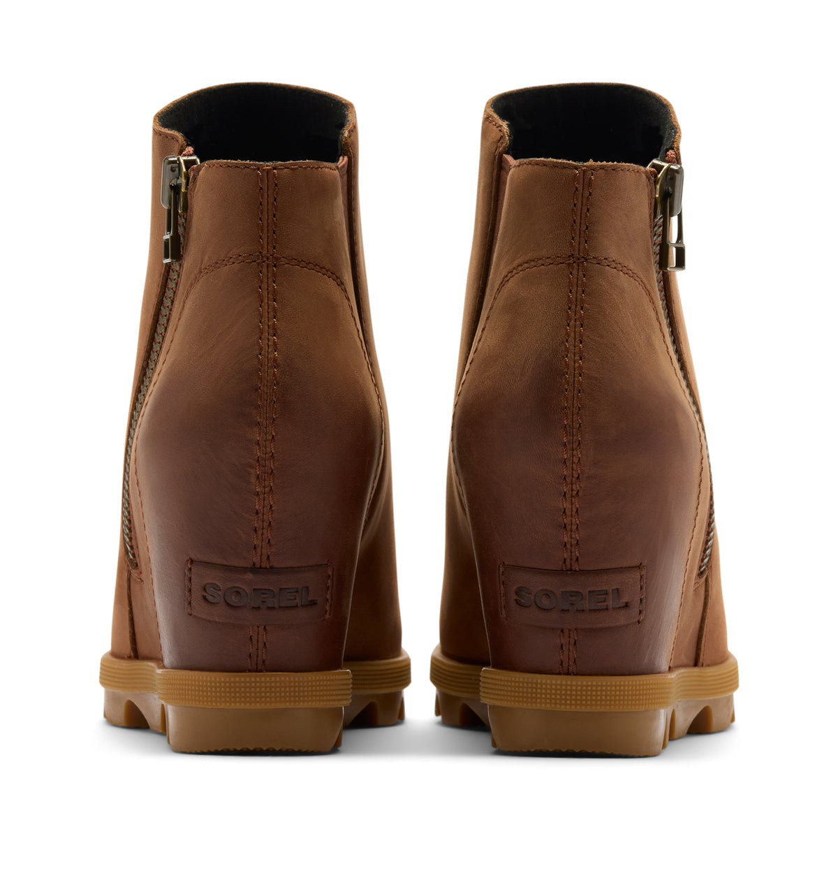 A pair of Sorel brown leather wedge ankle boots shown from the back, featuring side zippers, wedge heels, and tan rubber soles on a white background.
