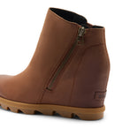 A brown leather ankle boot with a side zipper, wedge heel, and a thick lug sole, shown from a three-quarters angle on a white background.