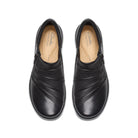 A pair of black leather slip-on shoes with diagonal stitched detailing on the toe, shown from a top-down view on a white background. The insoles show the Clarks Collection logo.