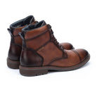 Pair of brown leather boots on a white background