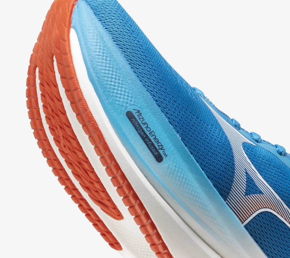 Blue running shoe with orange and white sole on a white background