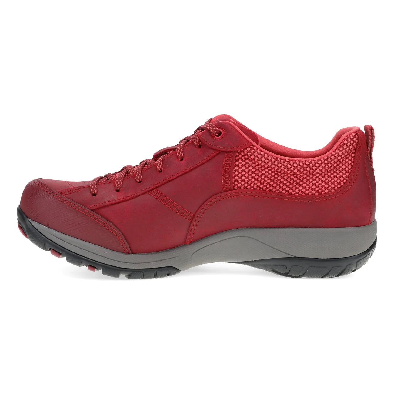 A red low-top walking shoe with a textured synthetic upper, matching red laces, a gray midsole, and a black outsole, shown from a side profile on a white background.
