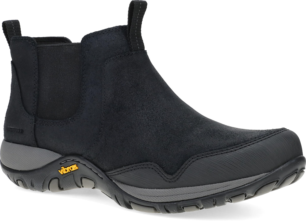 A black Chelsea-style ankle boot with a textured suede-like upper, elastic side gore, and a rugged black sole with a small yellow Vibram logo, shown on a white background.