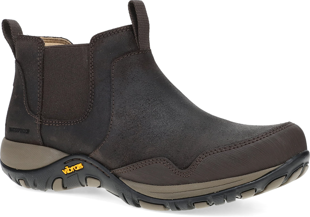 A dark brown Chelsea-style ankle boot with elastic side panels and a Vibram sole, shown from a three-quarters angle on a white background.