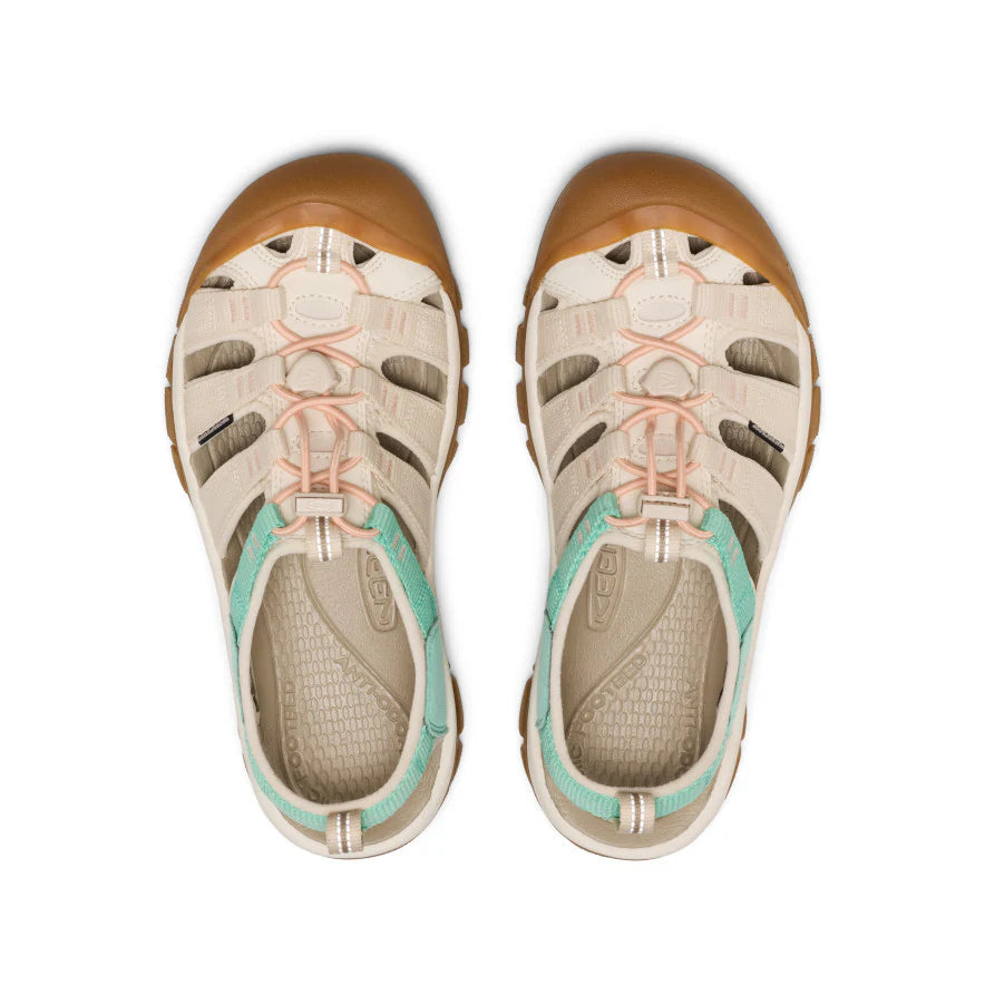 Pair of sandals with tan soles and multicolored straps on a white background