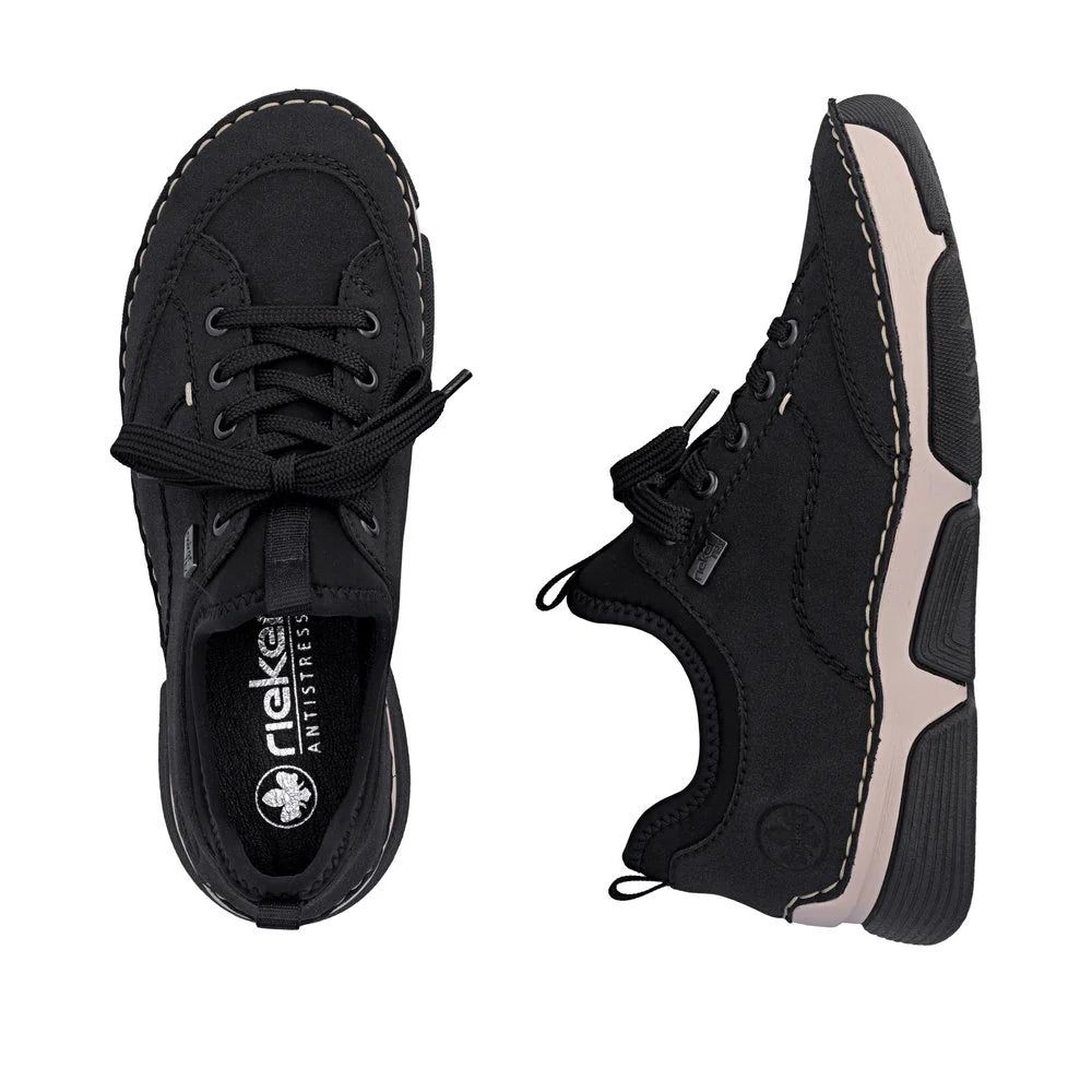 Black sneakers with beige accents on a white background