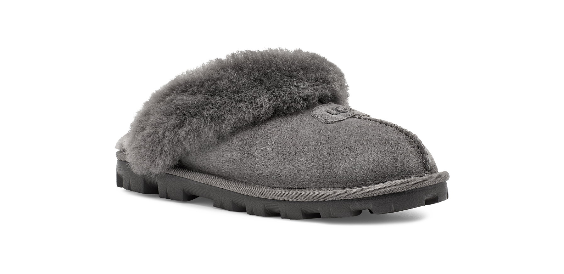 A single gray suede slipper with a thick, fluffy gray faux-fur trim across the top and a rugged black sole, shown from a side profile on a white background.