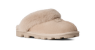A single beige slip-on slipper with soft shearling-style fur trim and a chunky lug sole, shown on a clean white background.