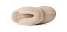 A single UGG slipper in beige suede with a soft cream shearling lining, shown from a side profile view against a solid white background.
