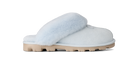 A single light blue slip-on slipper with fluffy faux-fur trim and a chunky beige sole, shown in profile against a solid white background.