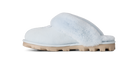 A light blue slip-on mule slipper with fluffy faux-fur trim and a chunky beige sole, shown in a side profile on a white background.