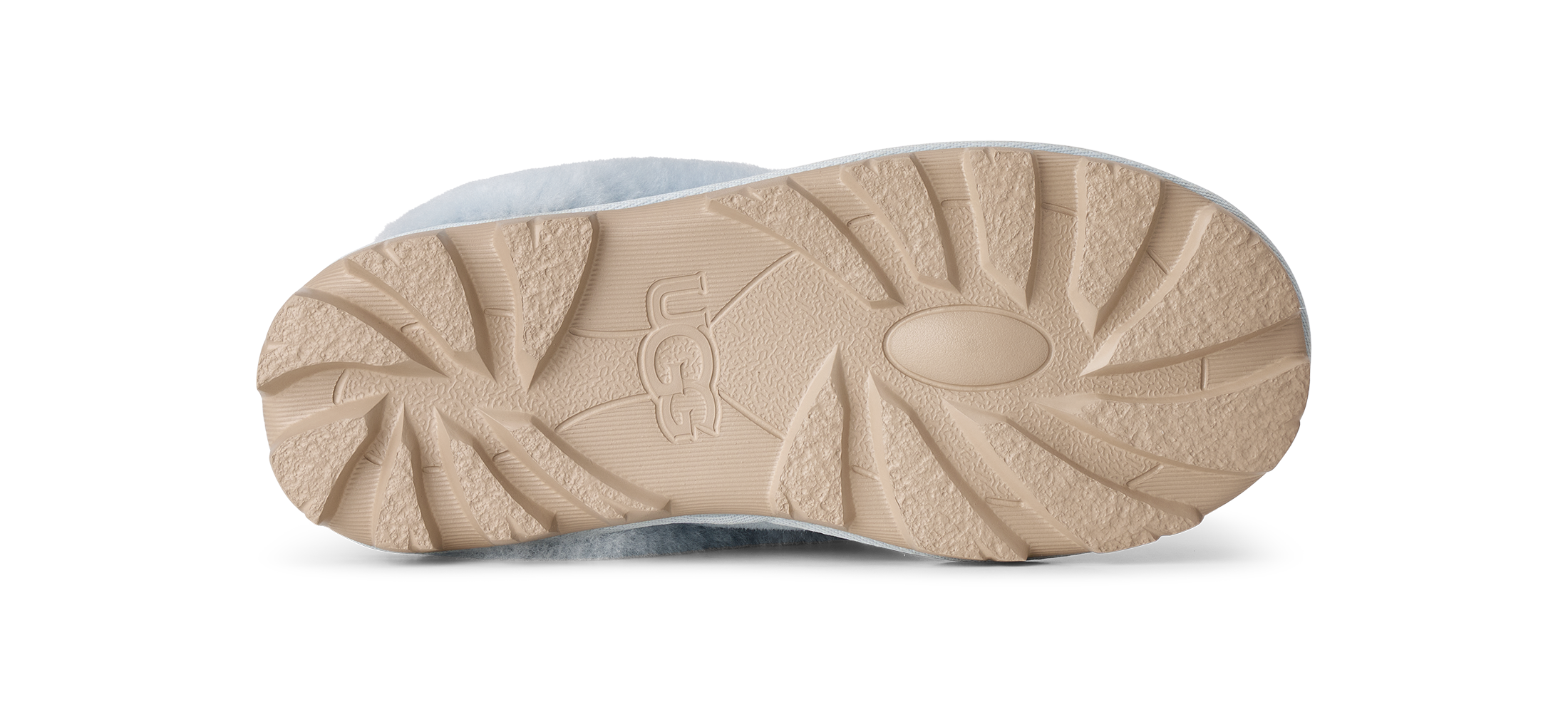 The beige rubber outsole of a UGG boot, showing the brand name embossed in the center, photographed from a top-down view on a white background.